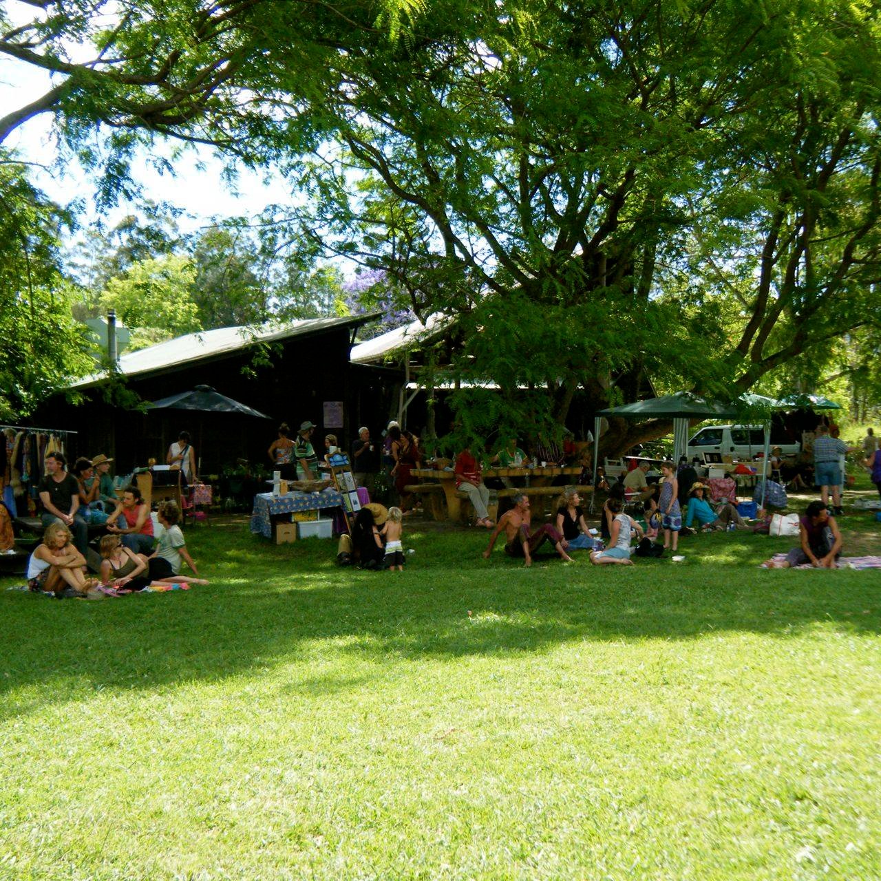 Residents and friends relax on the Village Green at Crystal Waters ...