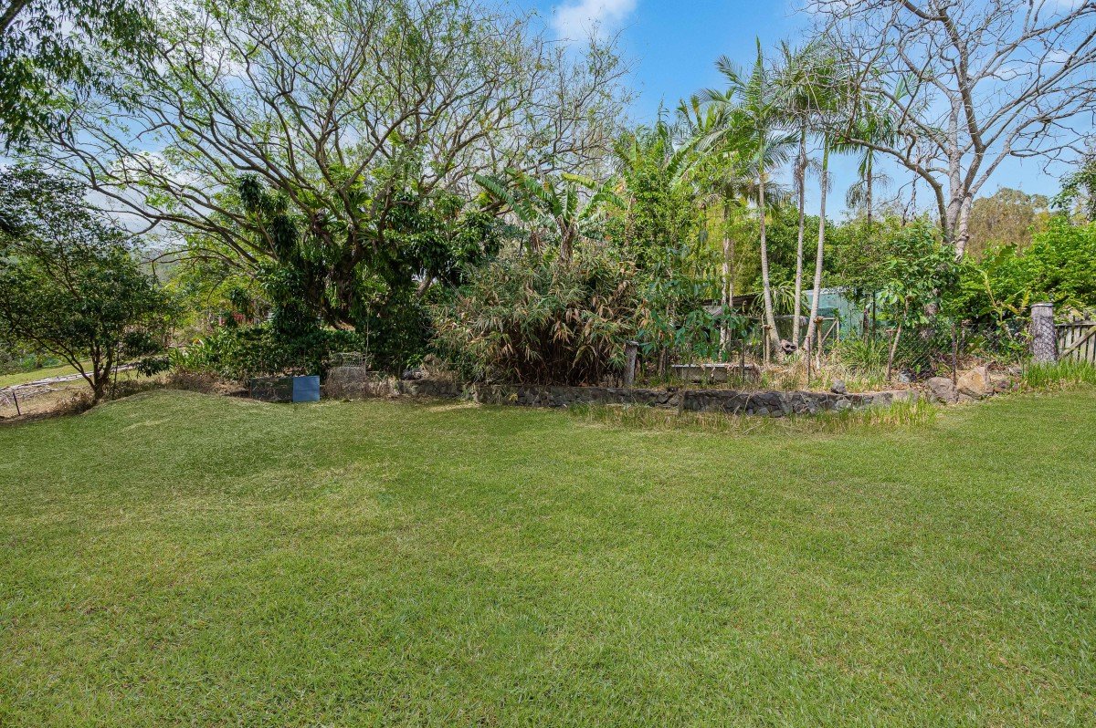 Open lawn surrounded by mature trees at 35/65 Kilcoy Lane, Conondale